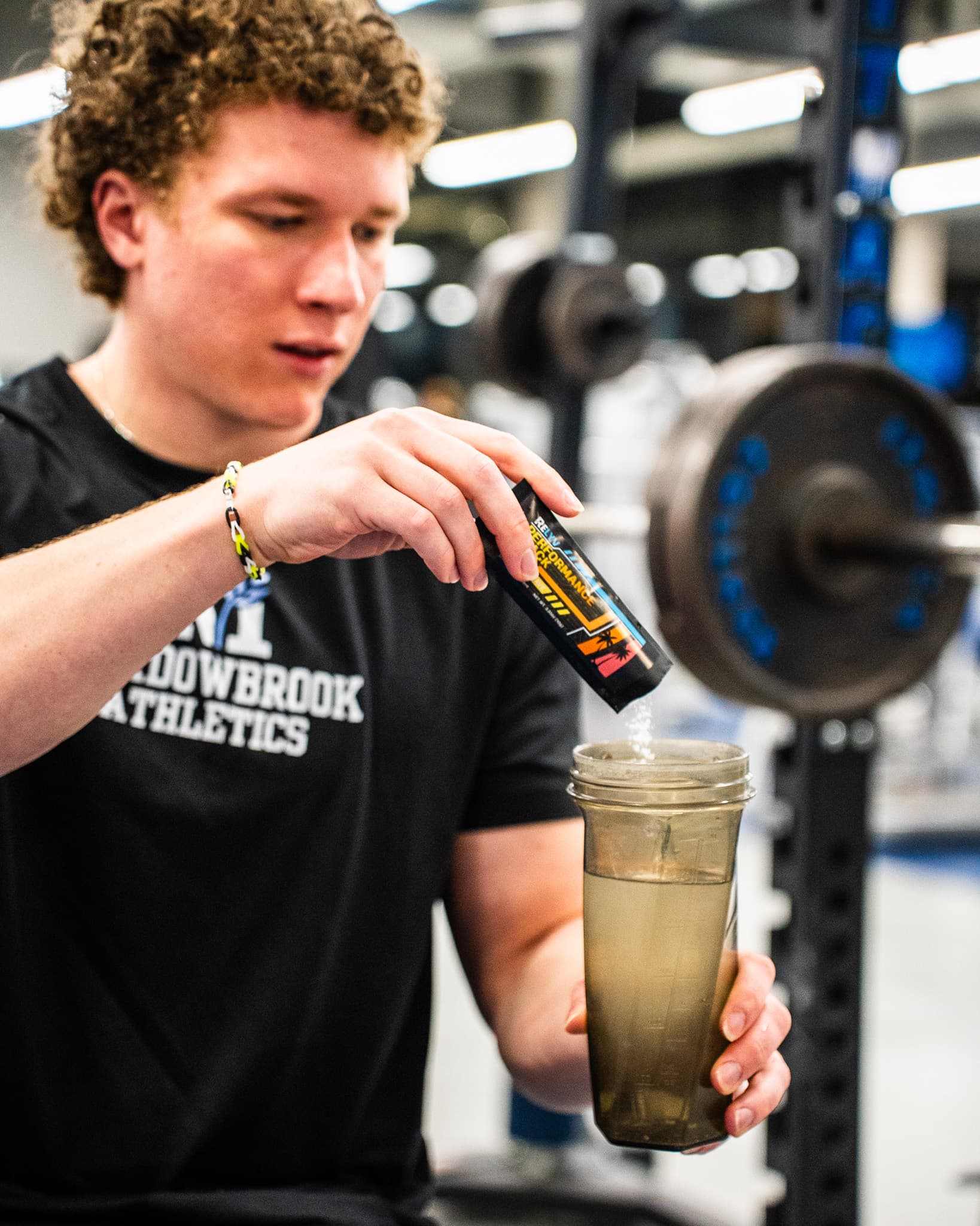 Jack, founder of Relyv, mixing the Relyv Performance Stack at the gym